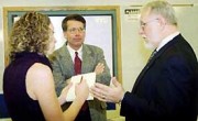 WVU Provost Jerry Lang (right) and James Lightbourne of the National Science Foundation talk to a reporter about a new Institute for Math Learning planned for WVU.