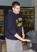 WVU student Chris Gregory 
demonstrates how to use a 
hand geometry reader to gain 
entry into the Student Recreation
Center.