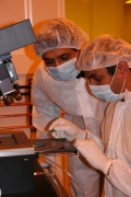 \"WVU engineering students Narsasimharao Ayyalasomyajula (left) and Raghu Chilakamarri (right) unload a patterned wafer from the photomask aligner in the new Nanosystems Clean Room housed in the College of Engineering and Mineral Resources, but share