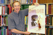 John Cuthbert, curator with the WVU Libraries\' West Virginia and Regional History Collection, shows the poster that will be handed out during West Virginia Day celebrations today (June 20) at Eliza\'s coffee shop in the Dowtown Campus Library. 