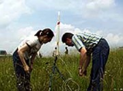 Eric Pyle (right), associate professor of science education, and Sara Wolak, an education major, prepare Wolak\'s rocket for lift-off at WVU\'s agronomy farm. Students in Pyle\'s \"This IS Rocket Science\" summer course are learni