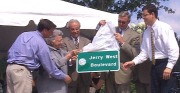 WVU and NBA basketball legend Jerry West unveils one of the signs that will mark a Morgantown street renamed for him.