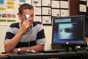 Stephen Schoenberger, a computer engineering and biometrics senior from Martinsburg, demonstrates the latest iris-scanning technology Friday during the Biometrics in Education Summit at WVU. The gathering was hosted in part by the Lane Department of Compu