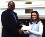 Ken Gray, vice president for Student Affairs, presents WVU student Kira Em Cronan with the $100 cash prize she won for submitting the winning name for an end-of-the-semester garage sale to benefit the United Way.