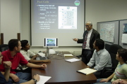 WVU professor Ismail Celik (standing) discusses syngas technology with his mechanical and aerospace engineering graduate and post-doctorate fellows in the Computational Fluid Dynamics and Applied Multiphysics Laboratory at the Engineering Research Buildin
