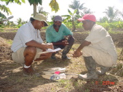 WVU\'s Rakesh Chandran, left, sets up a weed-control demonstration with local farmers during his visit to Guyana.  
