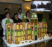 WVU Dining Services Nick Lapana, Vicki Van Pelt, Pam Kabbaj, Executive Chef Eric Filburn and Peggy Walden show off the gingerbread replica of Woodburn Hall they created as part of the president\'s holiday display at Blaney House.