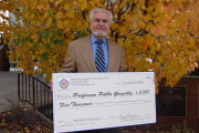 WVU foreign language professor Pablo Gonzalez shows the $5,000 check he received after winning the 2006 Cyrus R. Vance Award for International Education in West Virginia. Gonzalez donated the prize money to WVU\'s Department of Foreign Languages to a