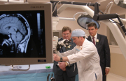 Julian Bailes, M.D., chair of neurosurgery at WVU, demonstrates surgical equipment in one of the six new operating rooms opened Wednesday at WVU Hospitals. Looking on are WVU President David Hardesty (right) and West Virginia Governor Joe Manchin. 

