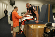 WVU alum Tim Bream (left), head athletic trainer for the Chicago Bears, works with linebacker Brian Erlacher, widely regarded as one of the best defensive players in the NFL. Bream credits WVU\'s athletic training program with giving him a solid foun