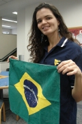 WVU student Livia Cascao shows the flag of her home country, Brazil. Cascao swam competitively on the Mountaineer Women\'s Swimming Team for four years and also mastered English while at WVU.