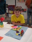 WVU\'s Community Arts Program gives children many opportunities to express their creativity. In this photo, student Megan Perry shows her work in last year\'s Saturday Art Studio class. The program also has classes for adults, and registration i