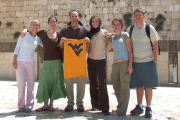 Jerusalem\'s Wailing Wall was one of the many stops last summer for a WVU group that included students and Dr. Aaron Gale (holding the Mountaineer T-shirt), who coordinates the Program for Religious Studies. Pictured with Gale are (from left), Ana Ra