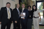 Jason Gross (center) displays the plaque he received for winning NASA Academy\'s prestigious Robert H. Goddard Research Award. NASA Academy officials pictured, from left, are: Dave Rosage, program director; Dr. Joseph Di Riemzi, academic dean; Tiffan