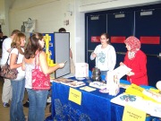 Crystal Goldyn and Gulsum Soyler-Ogretim (left to right behind table) introduce the new WVU Cooking Club to potential members. The WVU graduate students hope to promote healthier eating habits, cross-cultural understanding and happier taste buds with the 