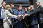 Outgoing president David C. Hardesty Jr. (center) wields the scissors during Wednesday\'s rededication of Oglebay Hall. The landmark building on the Downtown campus underwent a $23.5 million renovation and is now home to WVU\'s marquee Forensic 