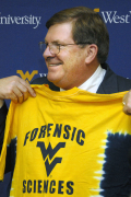 Outgoing WVU President David C. Hardesty Jr. has a big smile to go with the T-shirt he got during Wednesday\'s rededication of Oglebay Hall. The landmark building that was put up in 1918 is sporting a $23.5 million upgrade to go with its new mission 