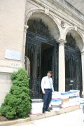 Nguyen The Cuong, the press attache at the Vietnam Embassy in Washington, D.C., pauses for a photo with books delivered from the WVU School of Journalism for universities in Vietnam.
