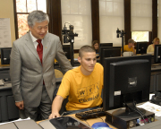 California businessman and philanthropist Ming Hsieh (standing) is committed to helping students like senior Travis Warner in the WVU Forensic and Investigative Science program achieve their goals with increased educational opportunities. Hsieh has put hi