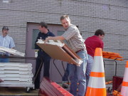 Mike Blankenship (center), former program coordinator for the WVU\'s West Virginia Local Technical Assistance Program (LTAP), helps load a work zone sign package - including signs, drums, cones, barricades, safety vests and other materials - during a