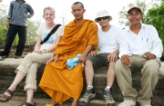 WVU School of Journalism student Kendal Montgomery (left) sits with a Buddhist monk, fellow student Robert Rizzuto and a Khmer man at Angkor Watt during a recent study abroad trip to Southeast Asia.