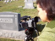 WVU P.I. Reed School of Journalism professor Gina Martino Dahlia shoots video for her documentary at one of the Monongah grave sites. 