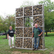 Alison Helm, chair of the Division of Art and Design in the WVU College of Creative Arts, and contemporary artist Kevin Lyles of Gallipolis, Ohio, flank Lyles' sculpture on the grounds of the Creative Arts Center. Lyles is a former visiting sculptor 