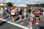 Members of the West Virginia University Mountaineer Marching Band stand in formation during practice. With the new school year just around the corner, the band has started practicing this week in the lot beside the Coliseum.