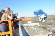 Students push their package off the roof of the Engineering Sciences Building during Friday's Pumpkin Drop at WVU. Participants had to design an apparatus to protect their pumpkins as they fell 11 floors to the ground.