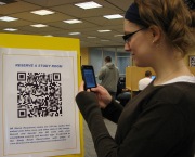 Miriam Newman, a graphic design junior, uses her iPhone to reserve a study room at the Evansdale Library.