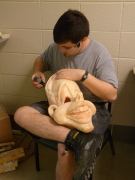 Andy Swisher smoothes down one of the masks from the mold