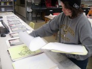 Student Kelsie Lilly helps collate the prints
