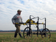 Symposium presenter Dr. Jarrod Burks utilizes a three-probe fluxgate gradiometer (magnetometer) in his research of earthwork sites.