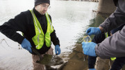 Ben Mack, from West Virginia Water Research Institute, collects soil from the Elk River for testing.