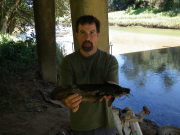 Stuart Welsh, adjunct associate professor of ichthyology at West Virginia University, holds a member of the species Tandanus tropicanus