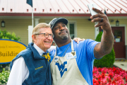 WVU President Gordon Gee takes a selfie outside the WVU Building